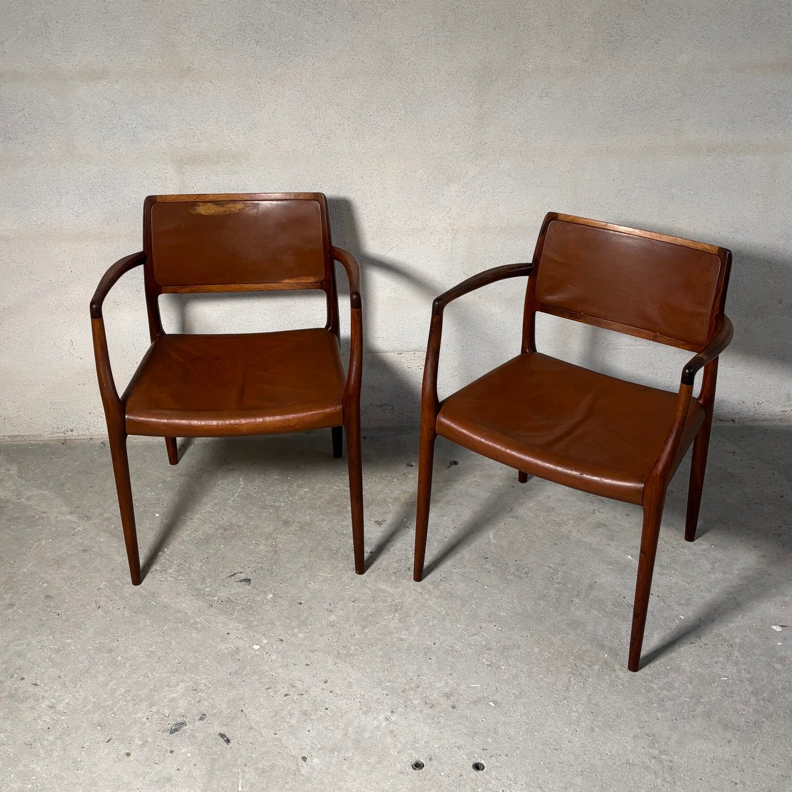 Pair of Niels O. Møller Model 65 armchairs in rosewood with original cognac leather, Denmark, 1960s